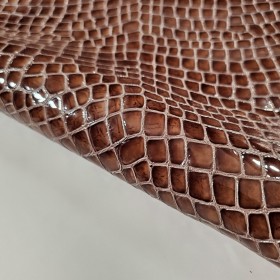 Bovine leather crocodile embossed in brown color.